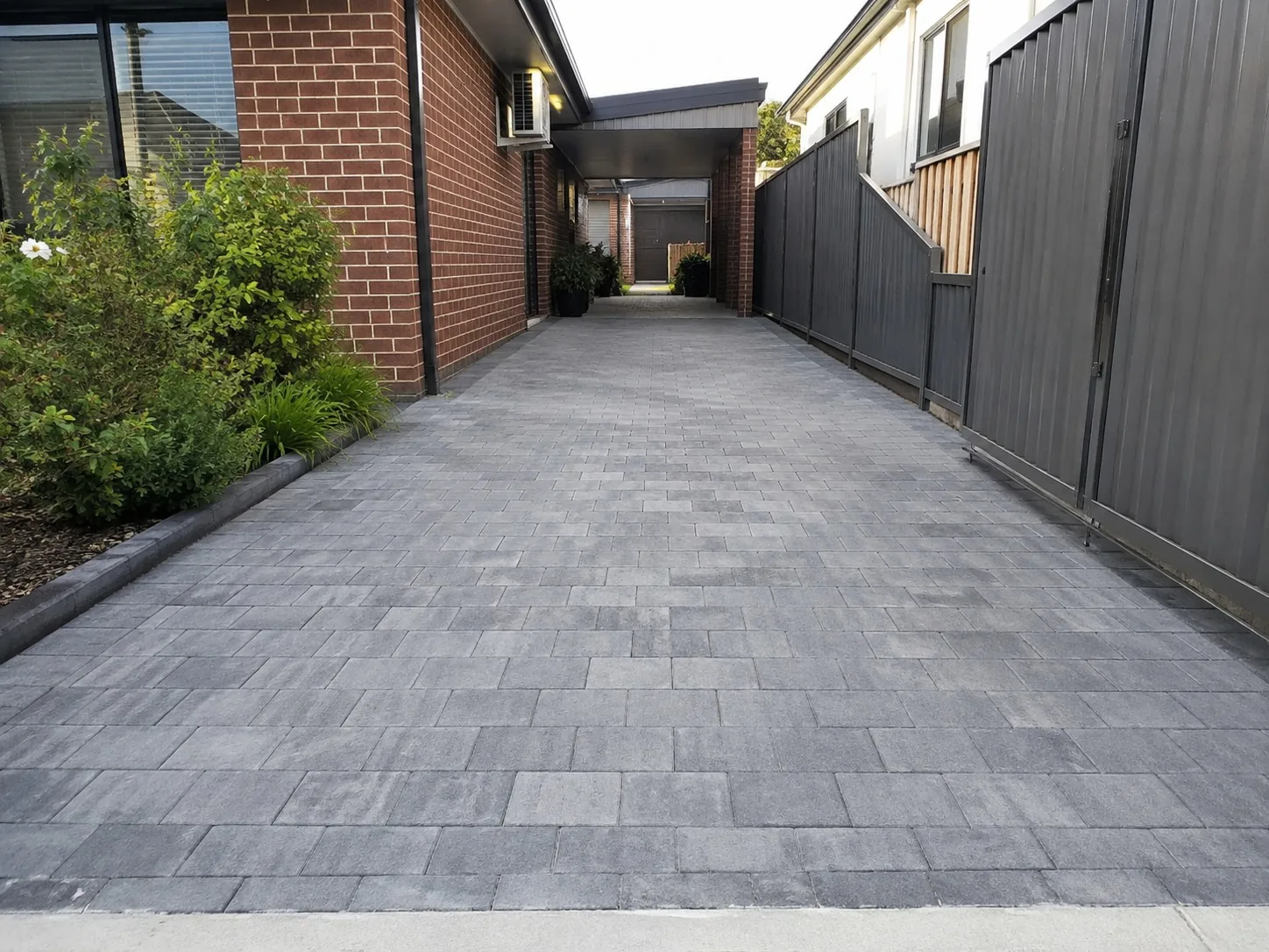 Paver-pattern stencil concrete running down the side access of a Newcastle home